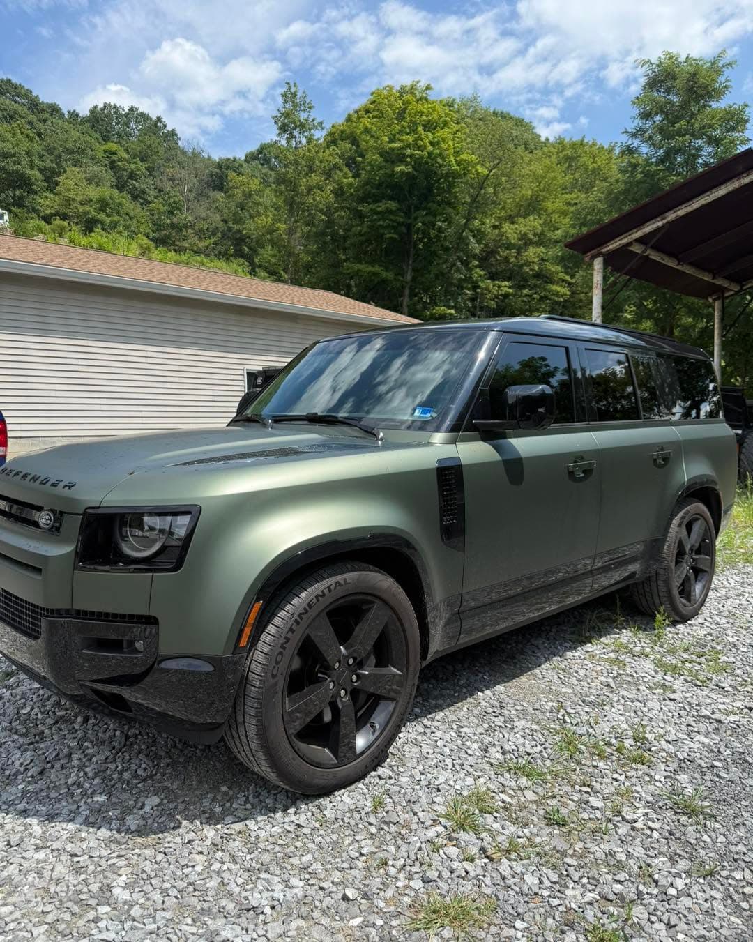 Green Land Rover Defender with window tint